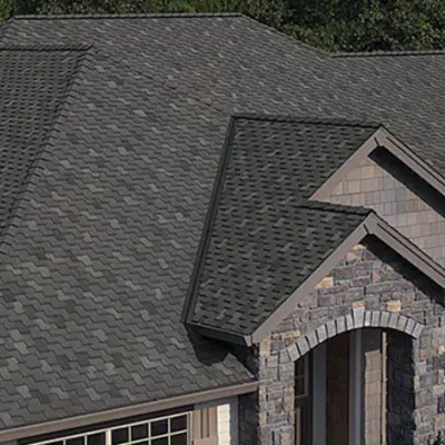 Image of a brown stone house with brown owens corning shingles
